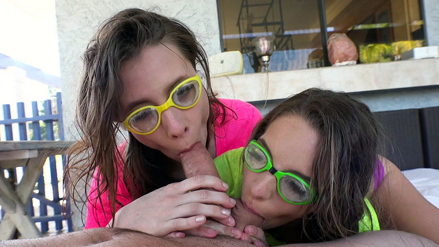 Two cute chicks with bright glasses share one dick and two balls